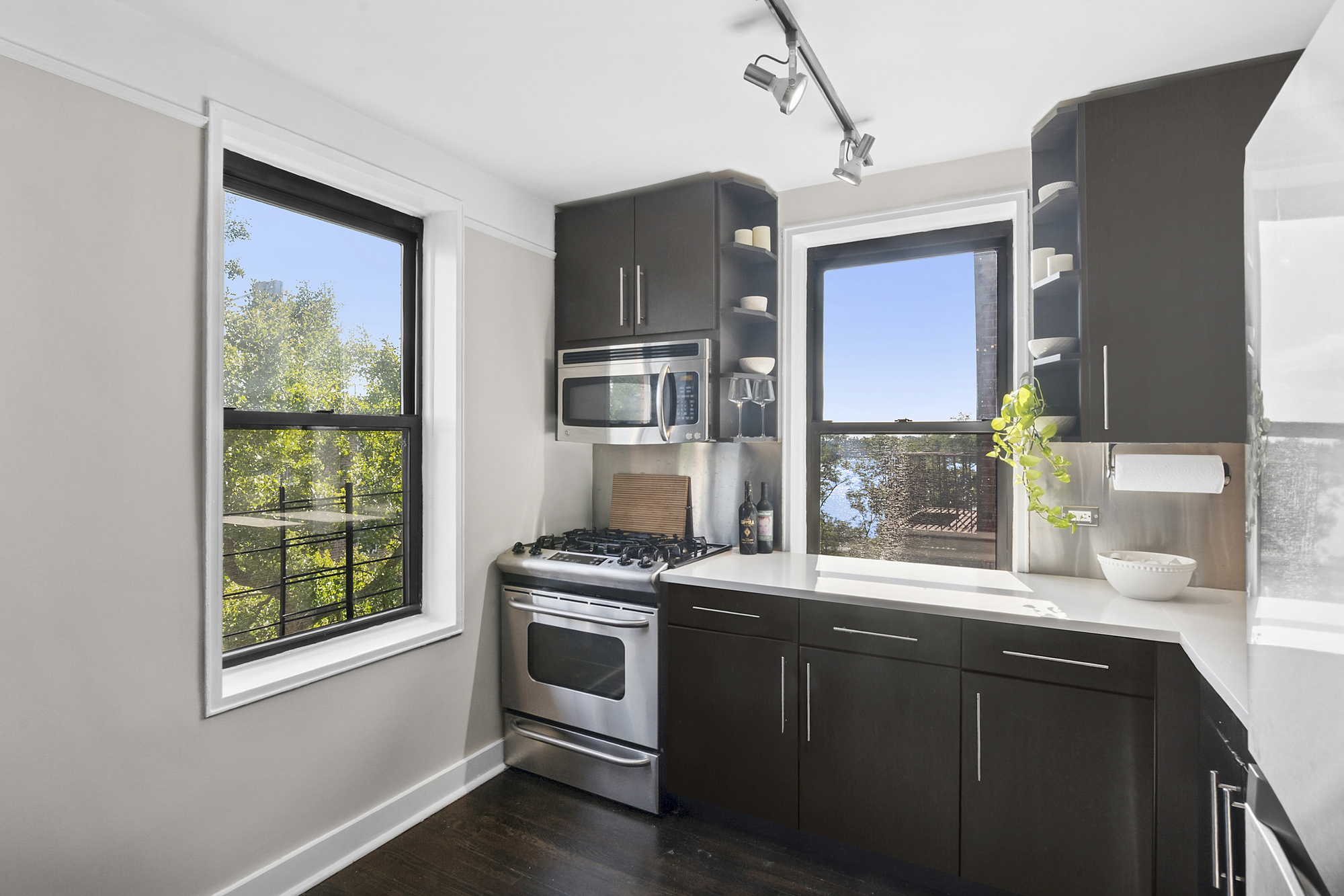 9511 Shore Road, Unit 606 Brooklyn, NY 11209 - Photo 4 of 17 a kitchen with stainless steel appliances granite countertop a stove a sink and a refrigerator