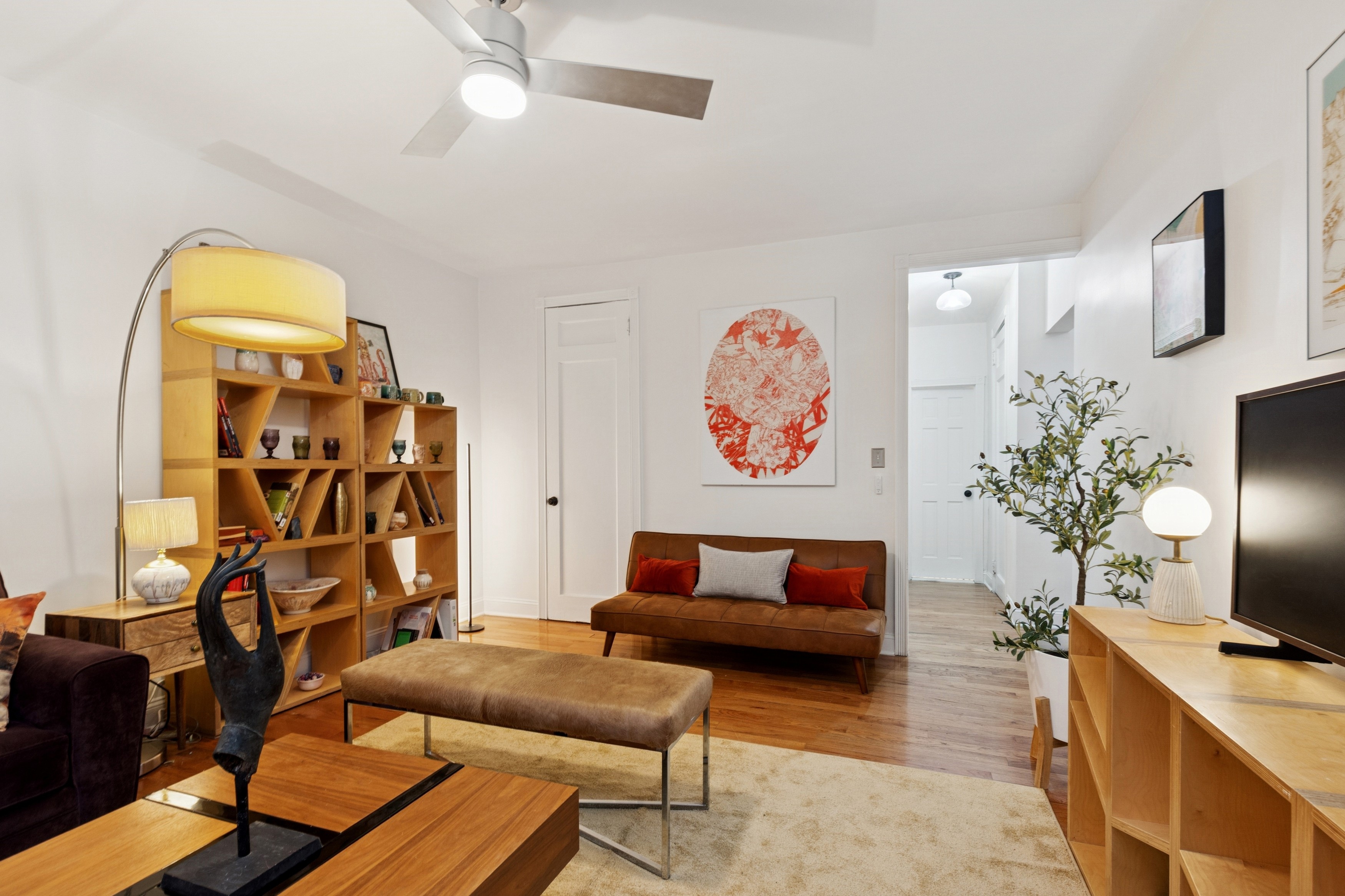 870 West 181st Street, Unit 2A Manhattan, NY 10033 - Photo 2 of 9 a living room with furniture and a flat screen tv