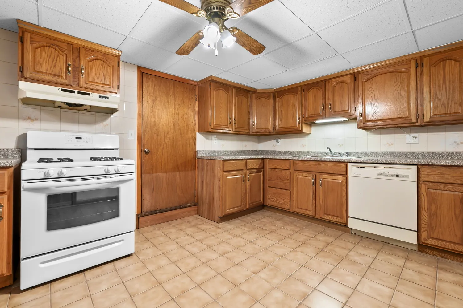 a kitchen with a stove sink and cabinets