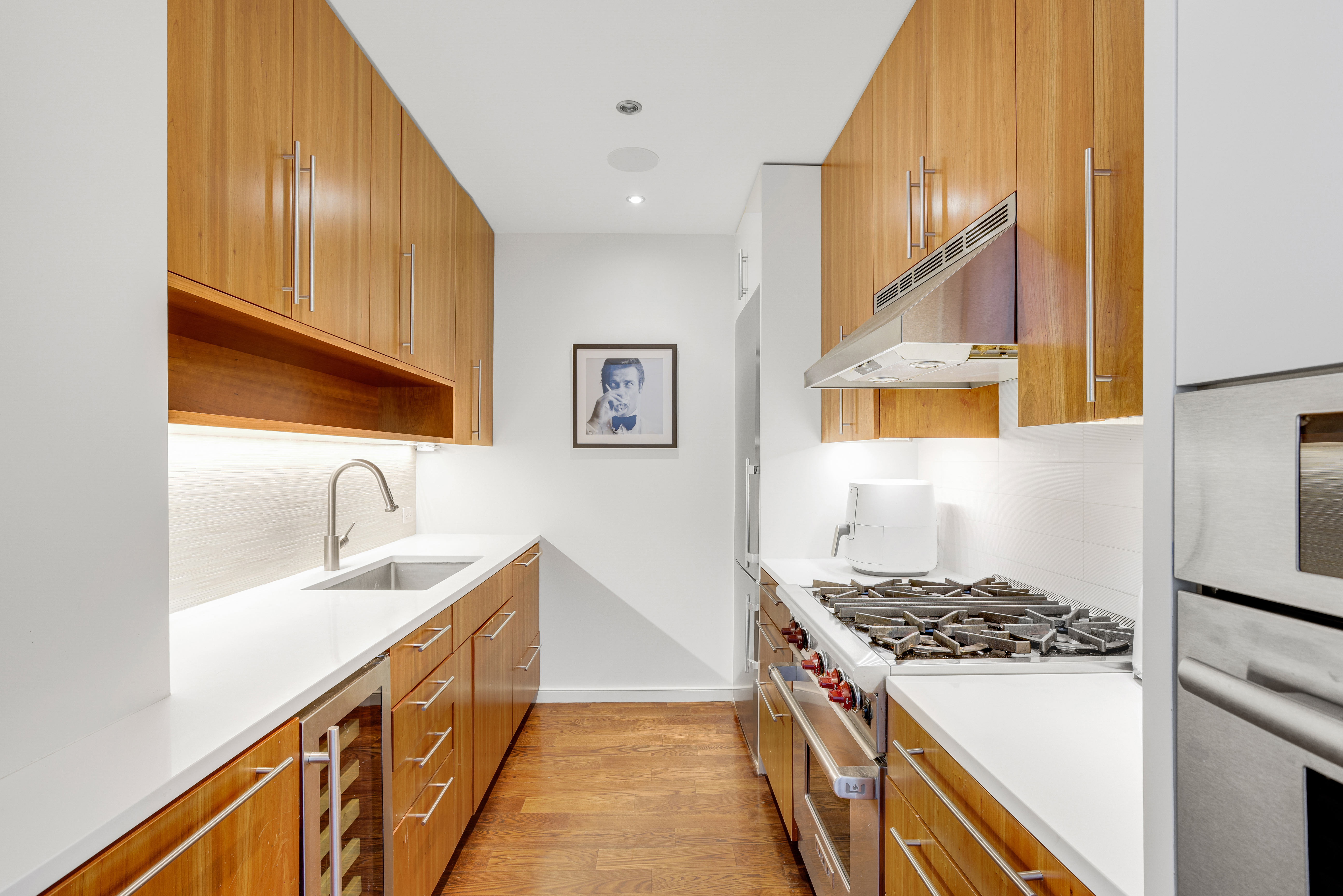 111 West 67th Street, Unit 34F Manhattan, NY 10023 - Photo 5 of 11 a kitchen with sink a stove and a refrigerator