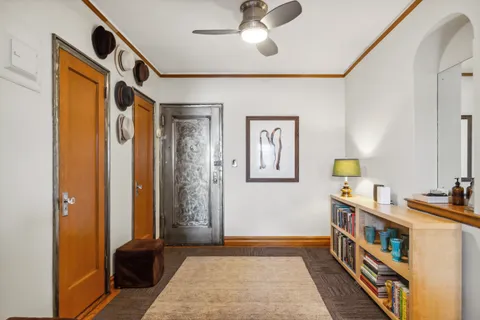 a hallway with furniture and chandelier