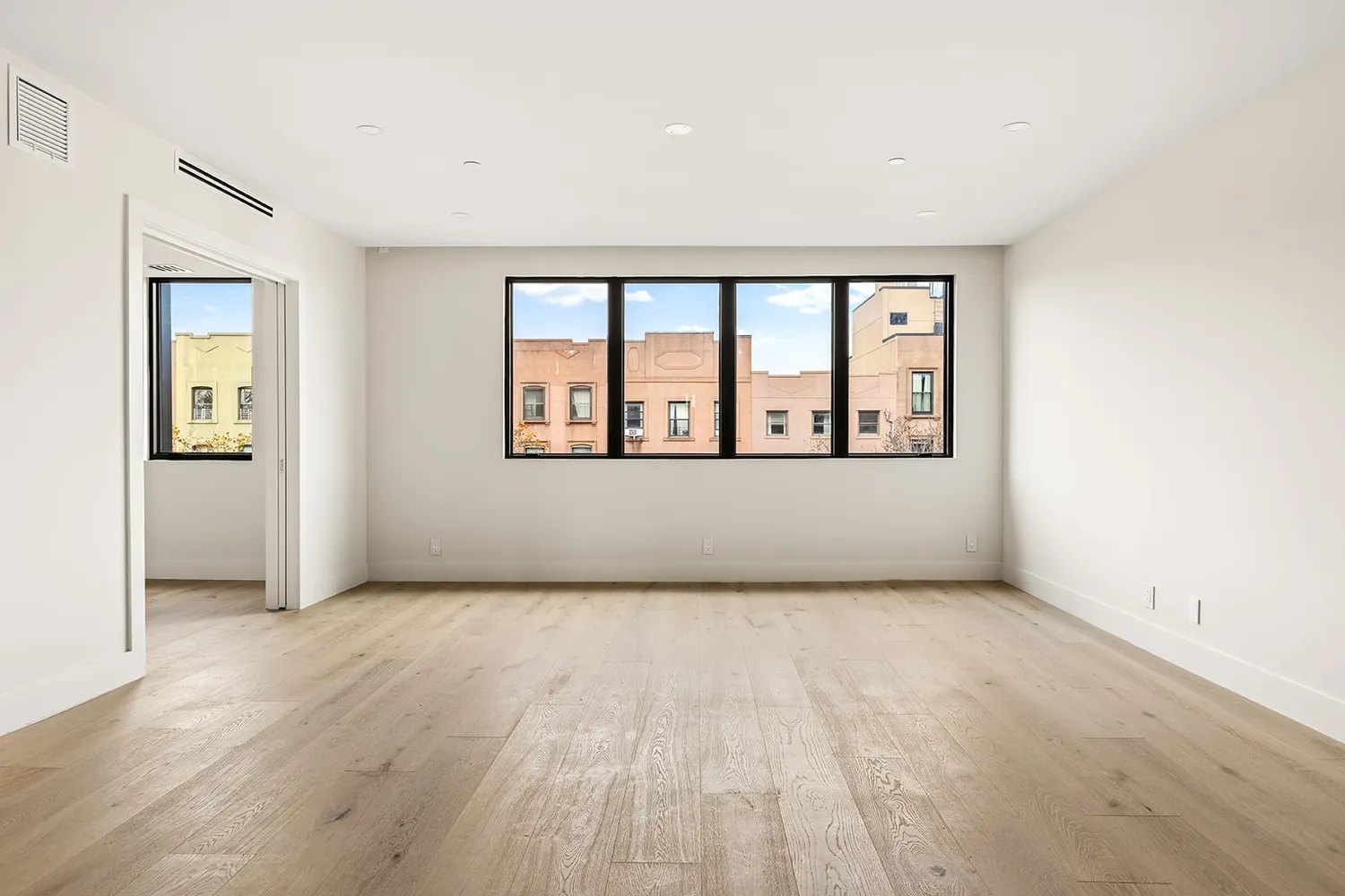 wooden floor in an empty room with a window