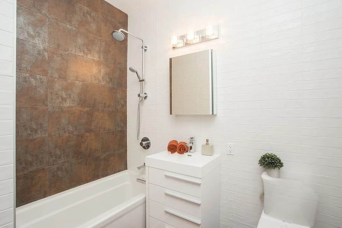 222 Withers Street, Unit 2A Brooklyn, NY 11211 - Photo 6 of 11 a bathroom with a bathtub sink and vanity