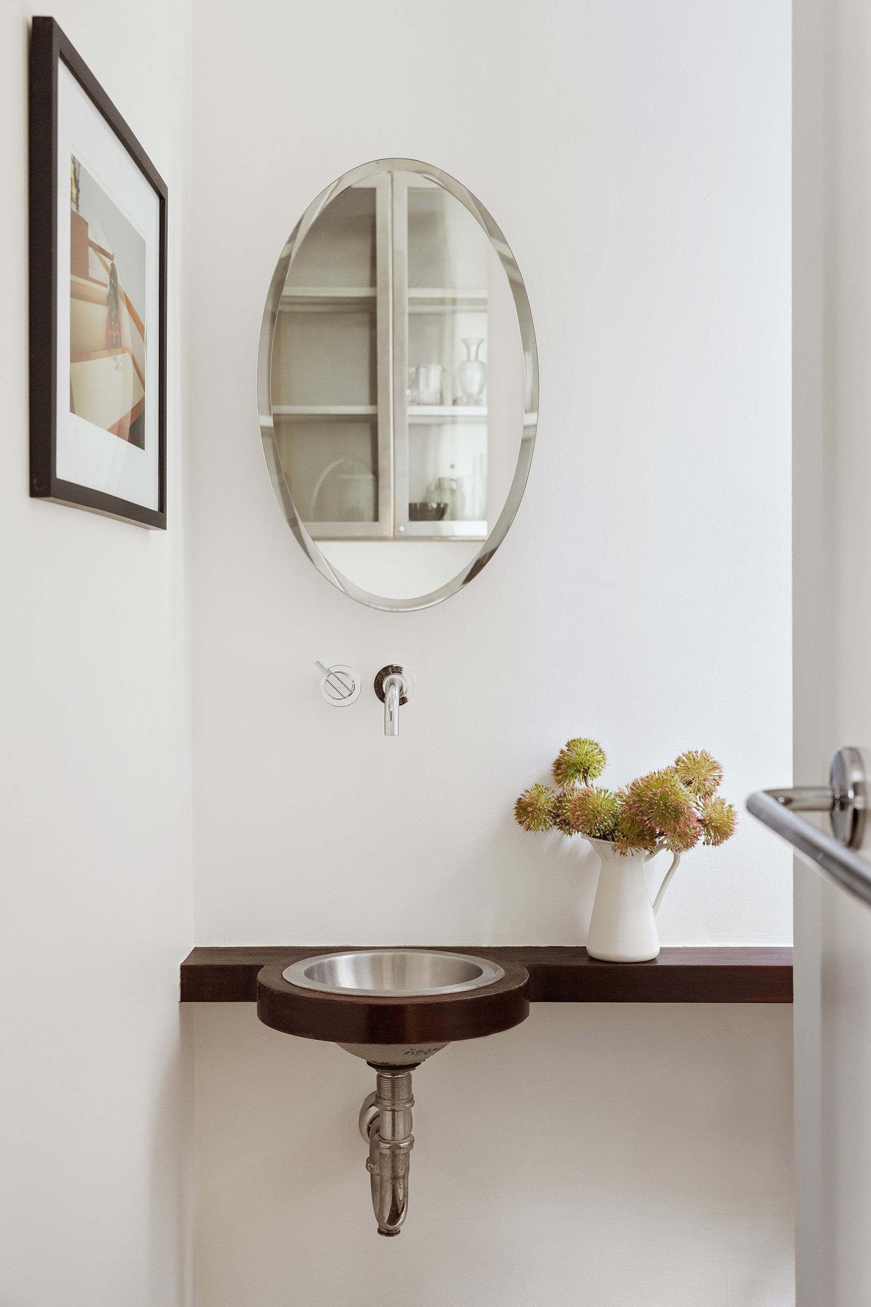 30 5th Avenue, Unit 4F Manhattan, NY 10011 - Photo 5 of 15 a bathroom with a sink and mirror