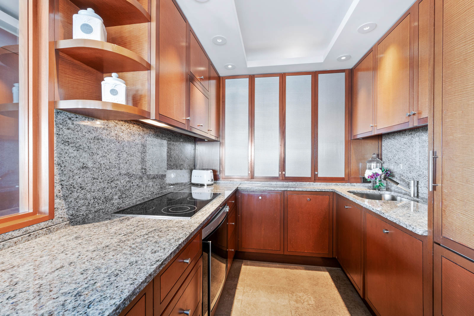 200 East 69th Street, Unit 44A Manhattan, NY 10021 - Photo 11 of 14 a kitchen with stainless steel appliances granite countertop a sink window and cabinets