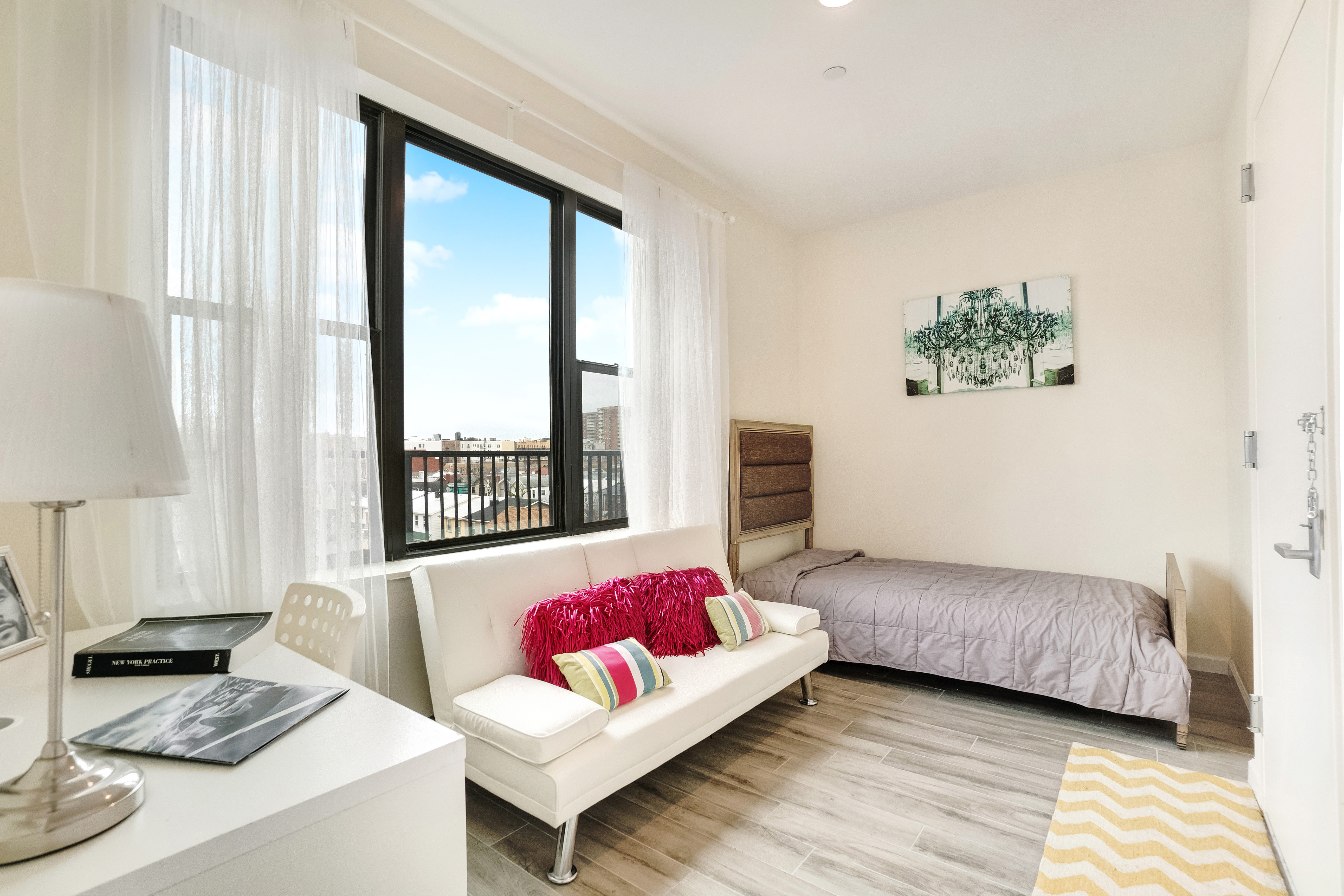 407 Oceanview Avenue, Unit PH Brooklyn, NY 11235 - Photo 9 of 16 a living room with furniture and a window