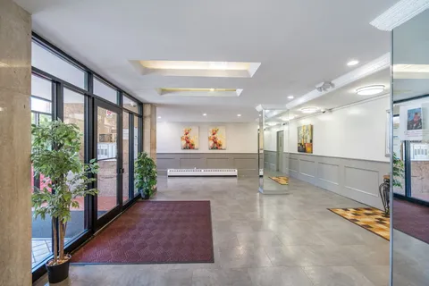a lobby with furniture and a potted plant