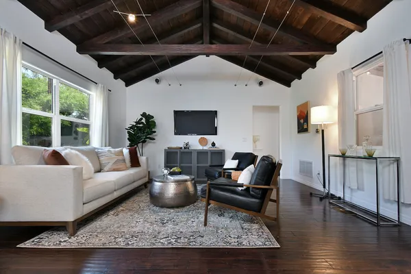 a living room with furniture wooden floor and a table