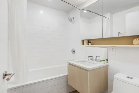 a bathroom with a sink a mirror and a bathtub