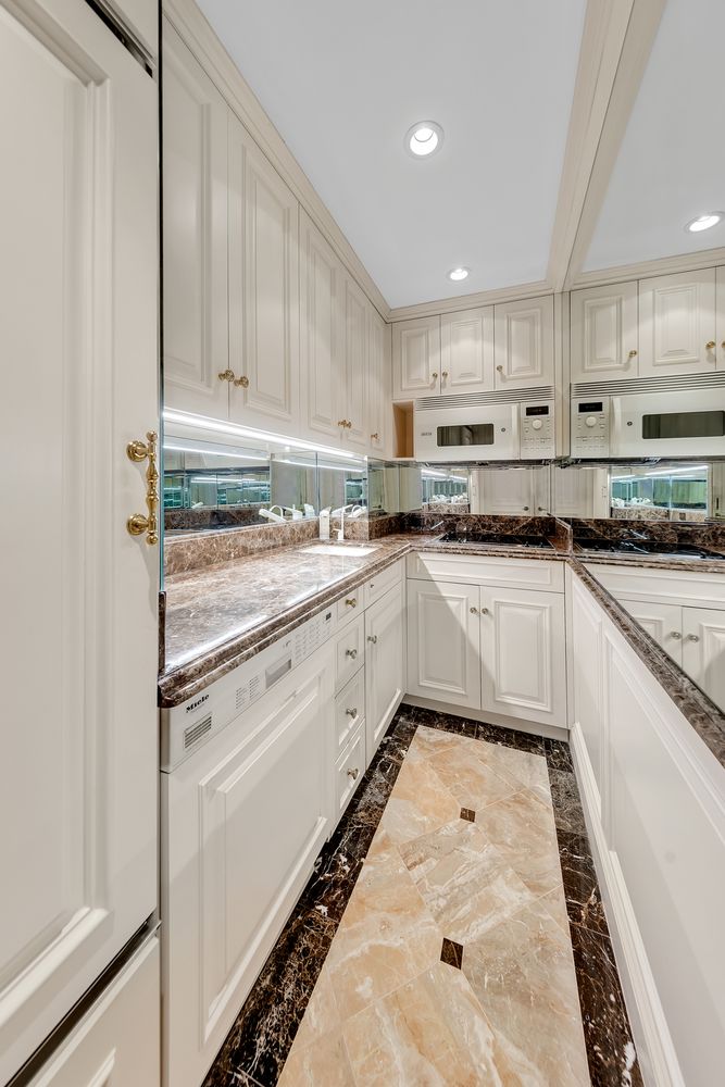 a kitchen with a white cabinets and white appliances