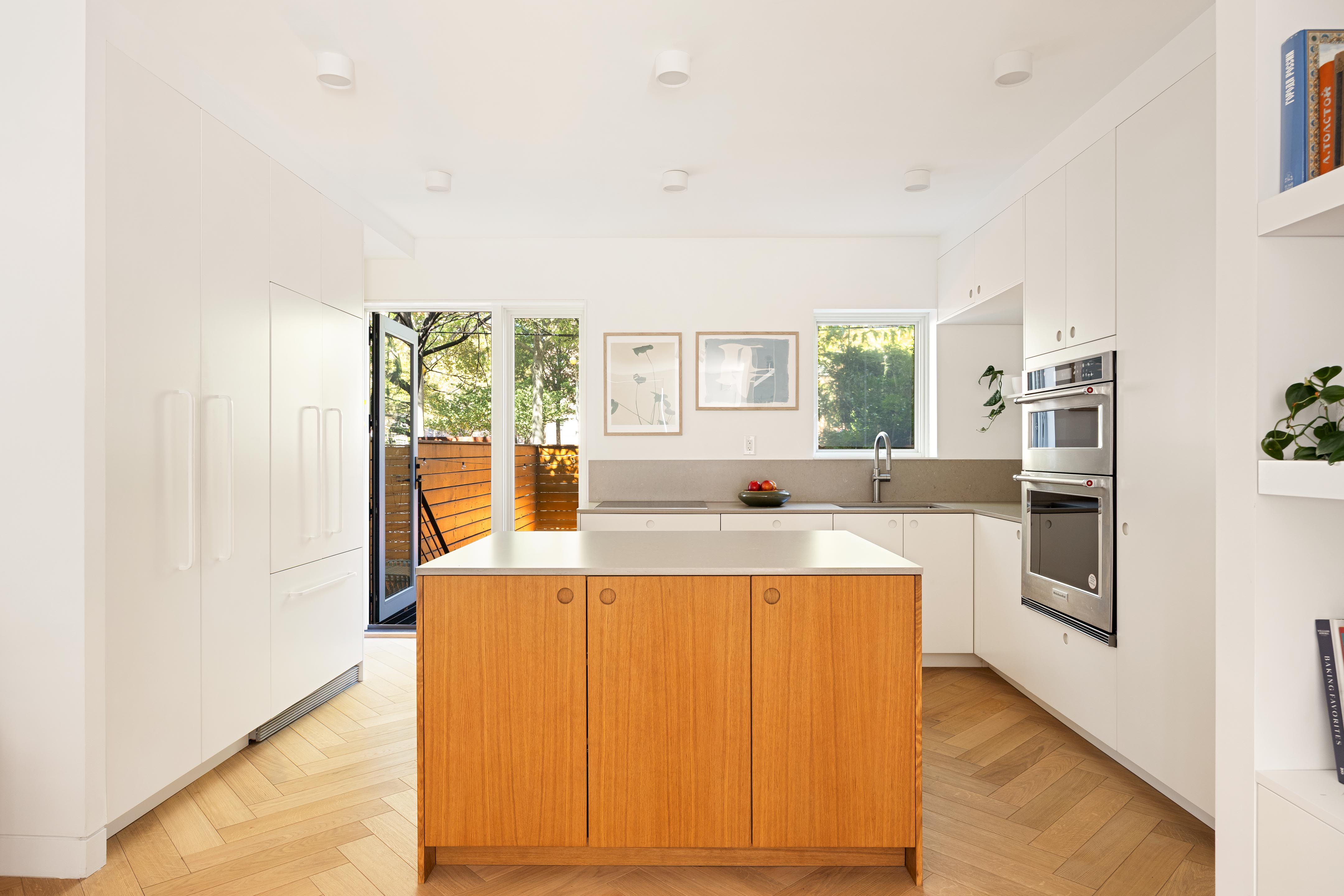 137 Maspeth Avenue Brooklyn, NY 11211 - Photo 6 of 18 a large white kitchen with a large window