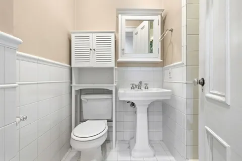 a bathroom with a sink toilet and mirror