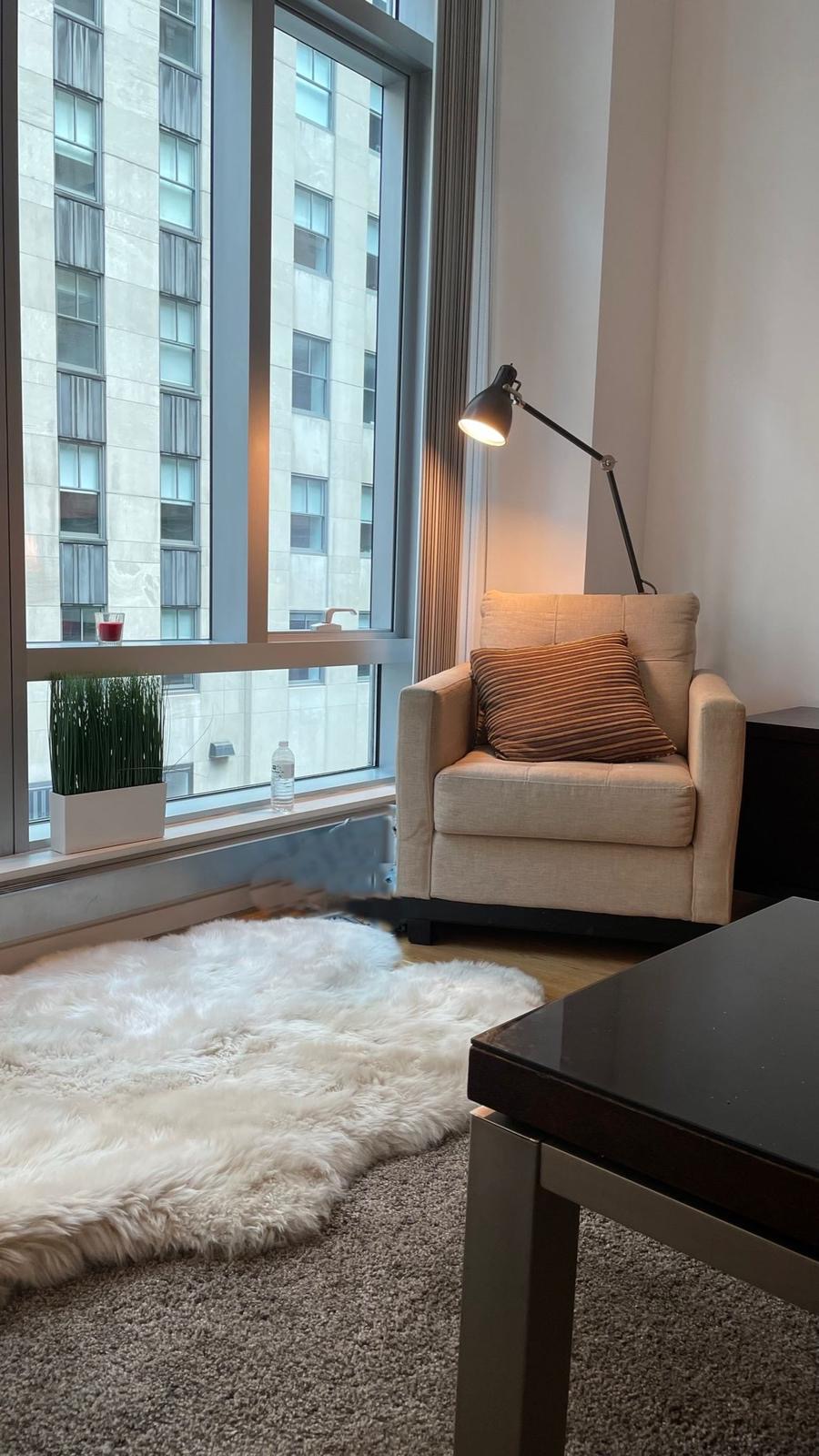 18 West 48th Street, Unit 3B Manhattan, NY 10036 - Photo 3 of 8 a living room with furniture and a couch