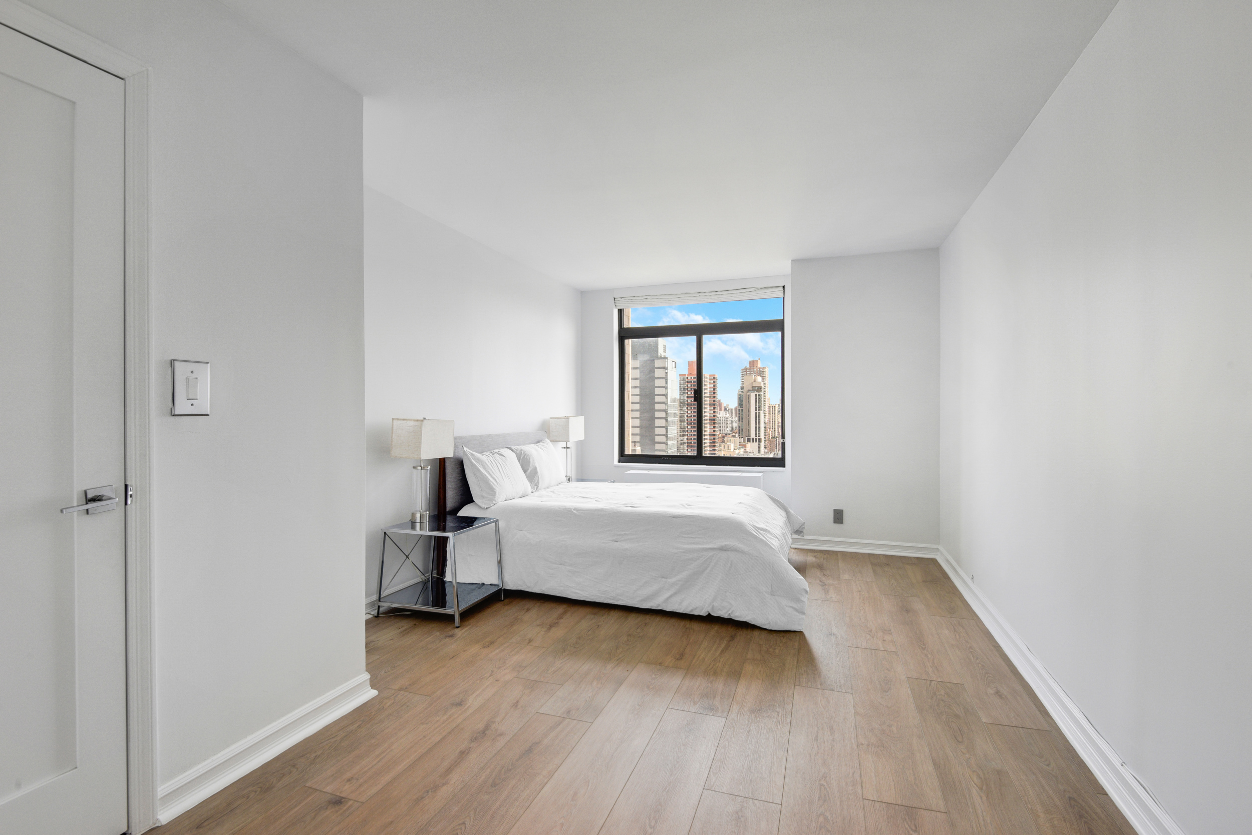 400 East 70th Street, Unit 3005 Manhattan, NY 10021 - Photo 10 of 18 a room with bed and window