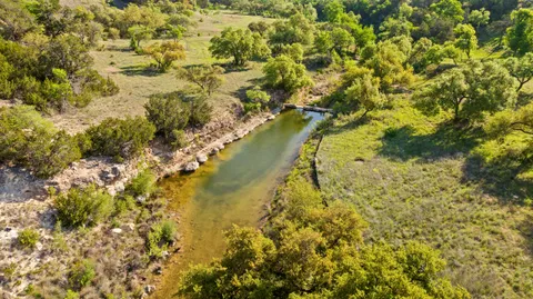 a view of a field with an ocean
