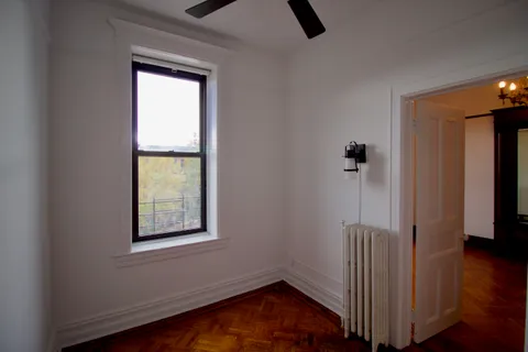 a view of an entryway with wooden floor and door