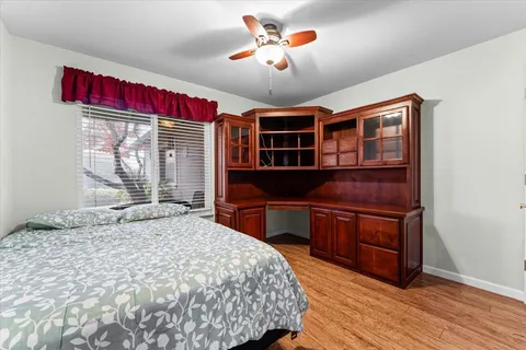 a bedroom with a large bed and wooden floor