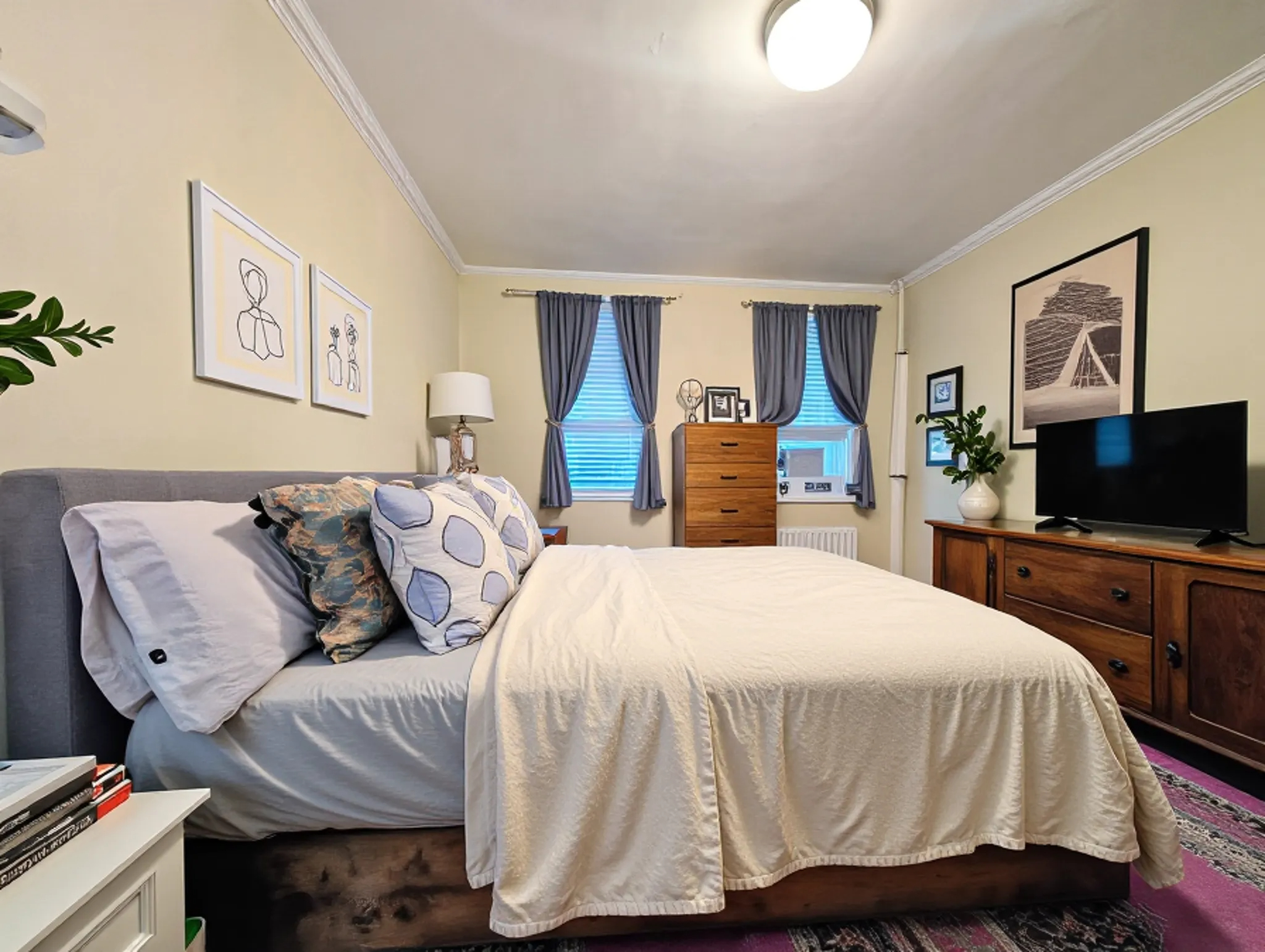 49 Saint Marks Avenue, Unit 1 Brooklyn, NY 11217 - Photo 7 of 21 a bedroom with a bed and a flat screen tv