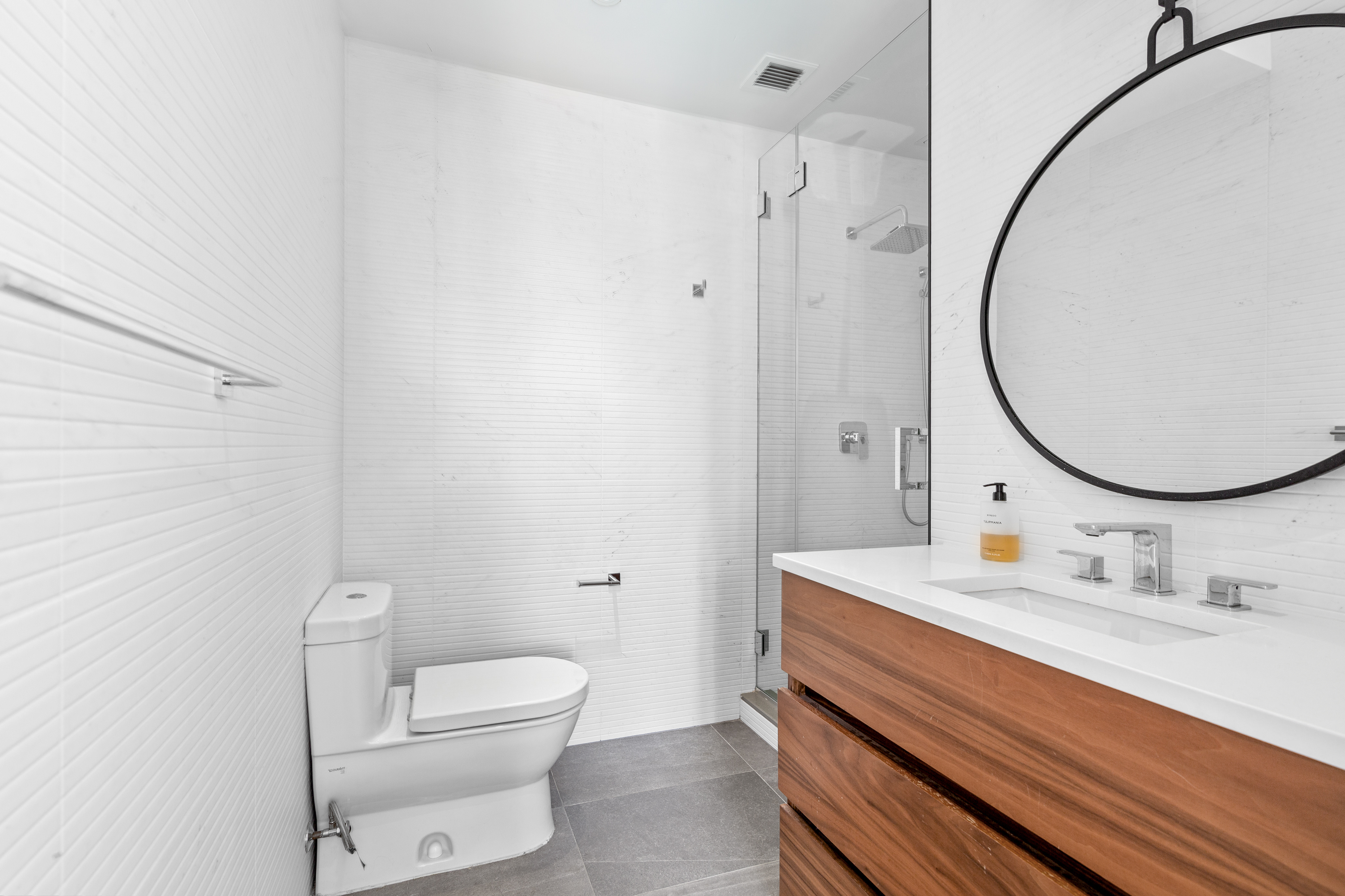 112 Fleet Place, Unit 12A Brooklyn, NY 11201 - Photo 10 of 15 a bathroom with a sink a toilet and a mirror