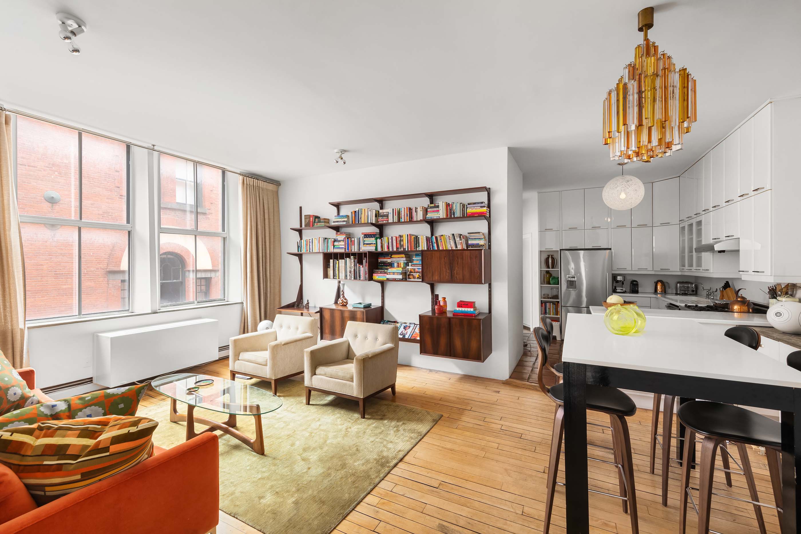 57 Laight Street, Unit 3 Manhattan, NY 10013 - Photo 3 of 15 a living room with furniture a rug and a large window