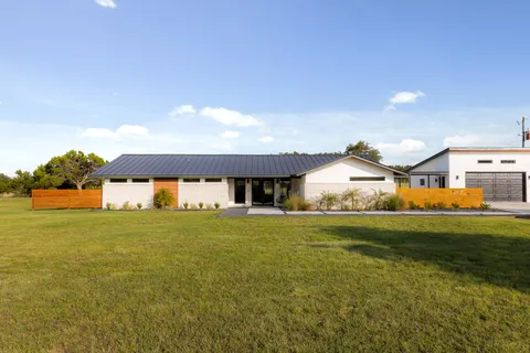 a front view of a house with a big yard