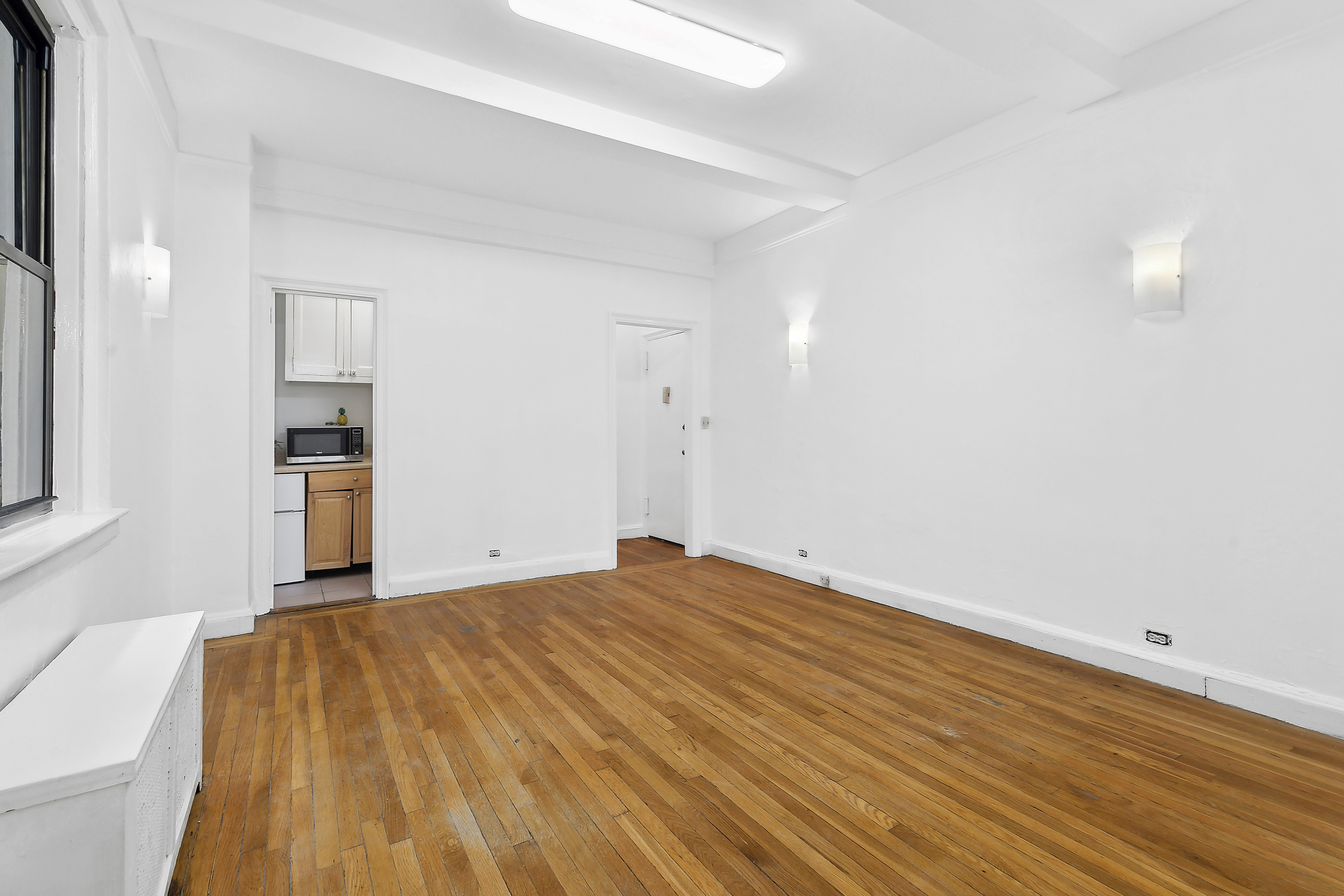 321 East 54th Street, Unit 1D Manhattan, NY 10022 - Photo 1 of 9 a bedroom with a bed and a window