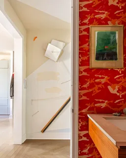 a bathroom with a toilet a sink and mirror