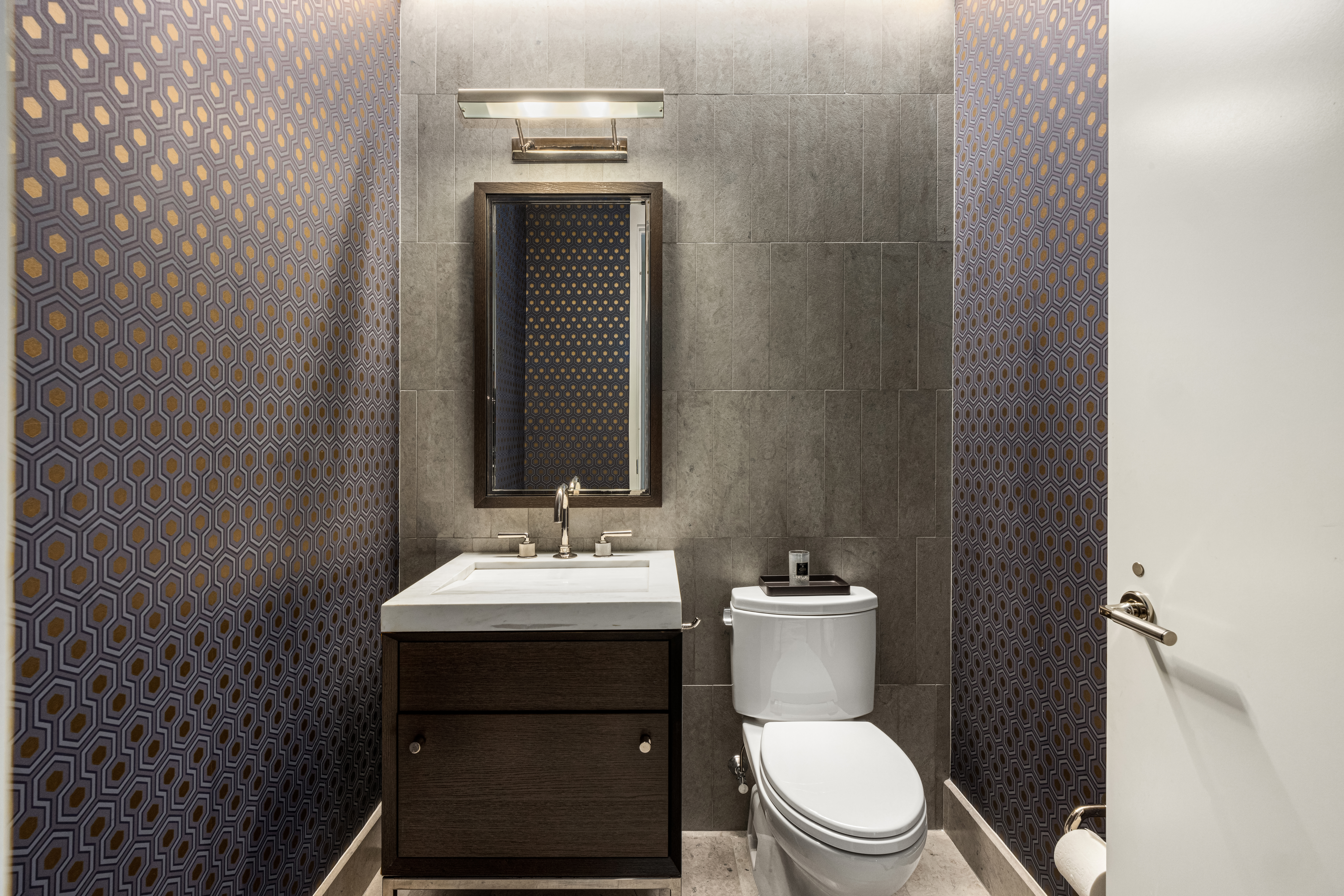 301 East 50th Street, Unit 8C Manhattan, NY 10022 - Photo 7 of 20 a bathroom with a toilet a sink and mirror