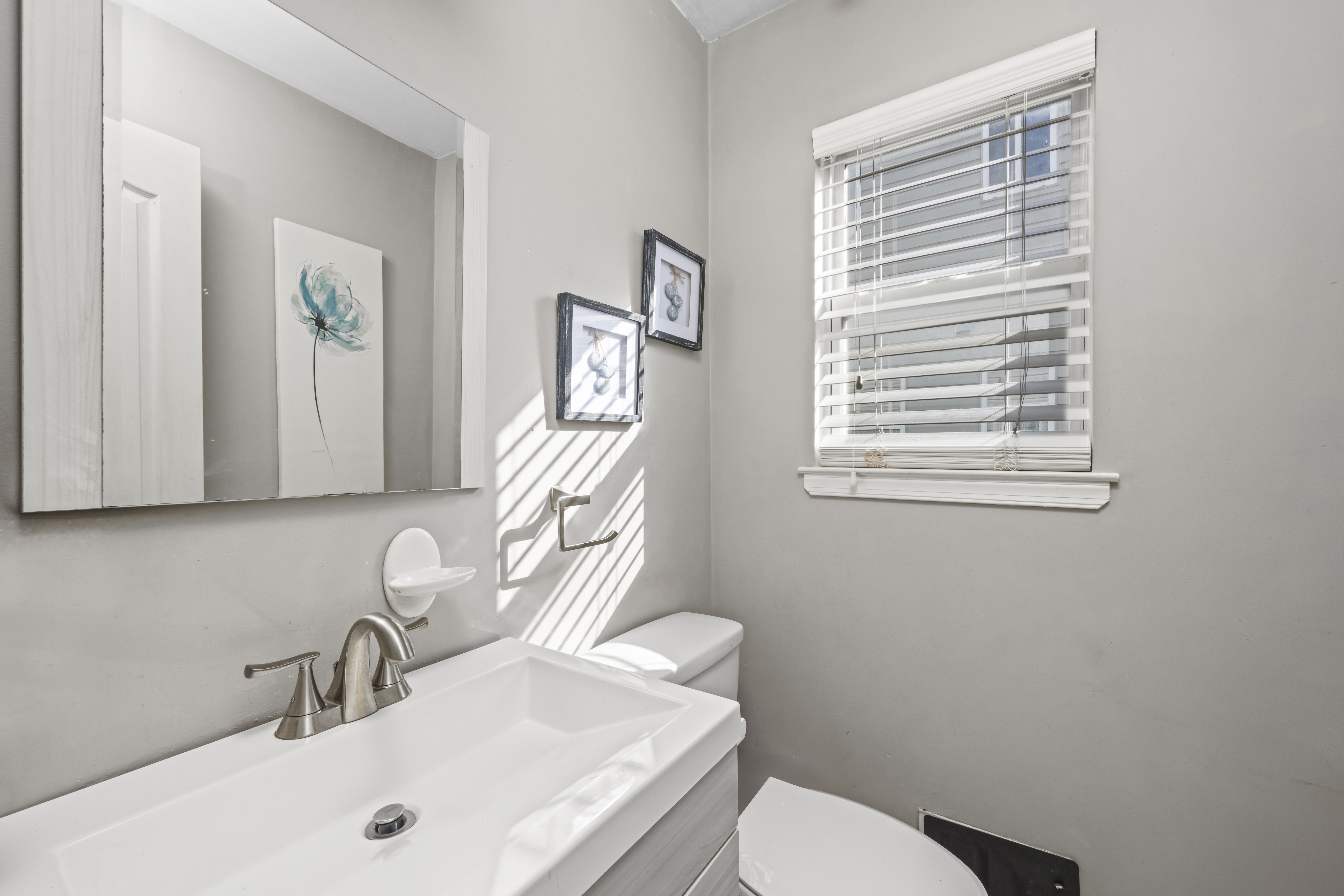 55 Sideview Avenue Staten Island, NY 10314 - Photo 6 of 28 a bathroom with a sink a toilet and a mirror