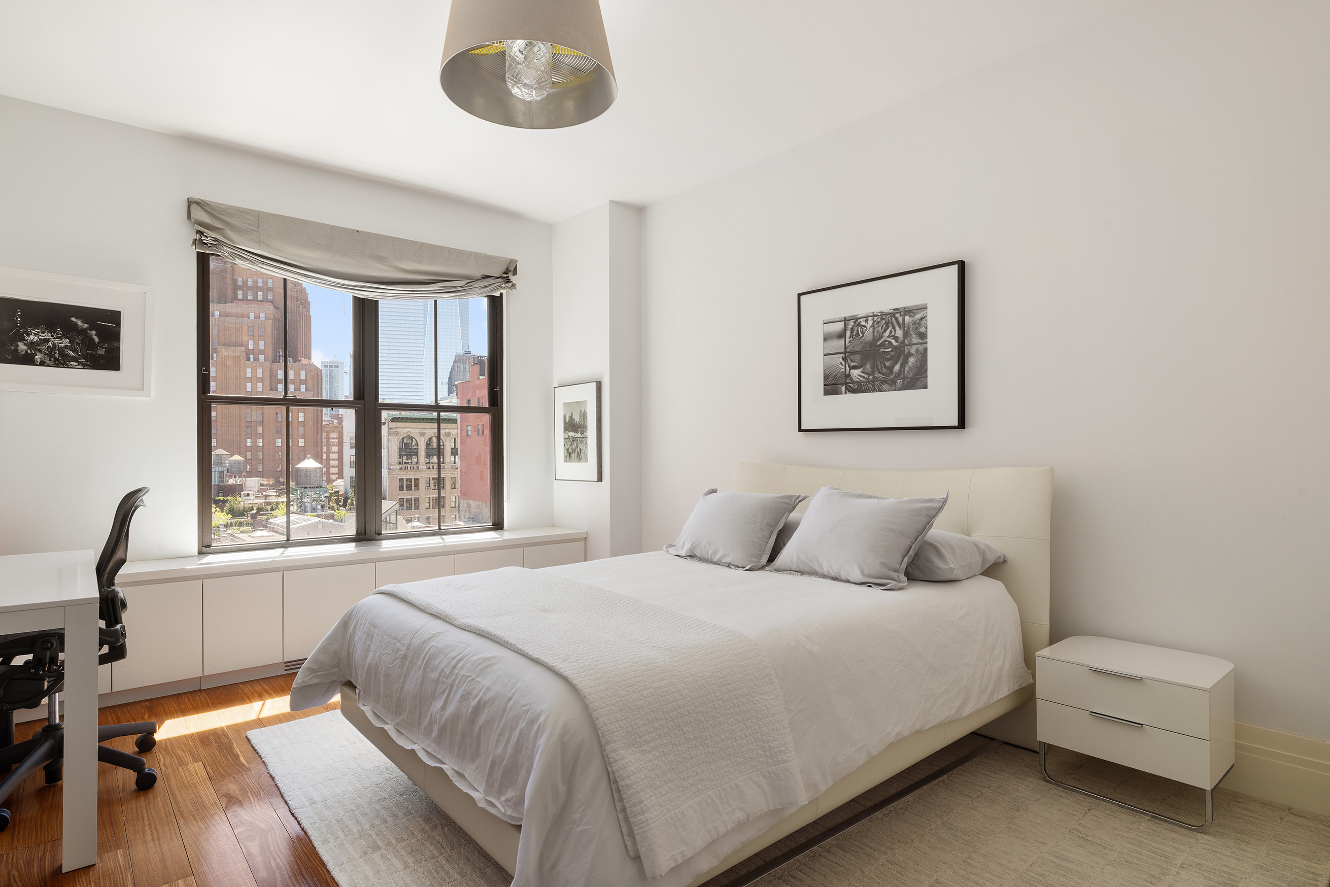 27 North Moore Street, Unit 10D Manhattan, NY 10013 - Photo 14 of 30 a bedroom with a bed and a large window