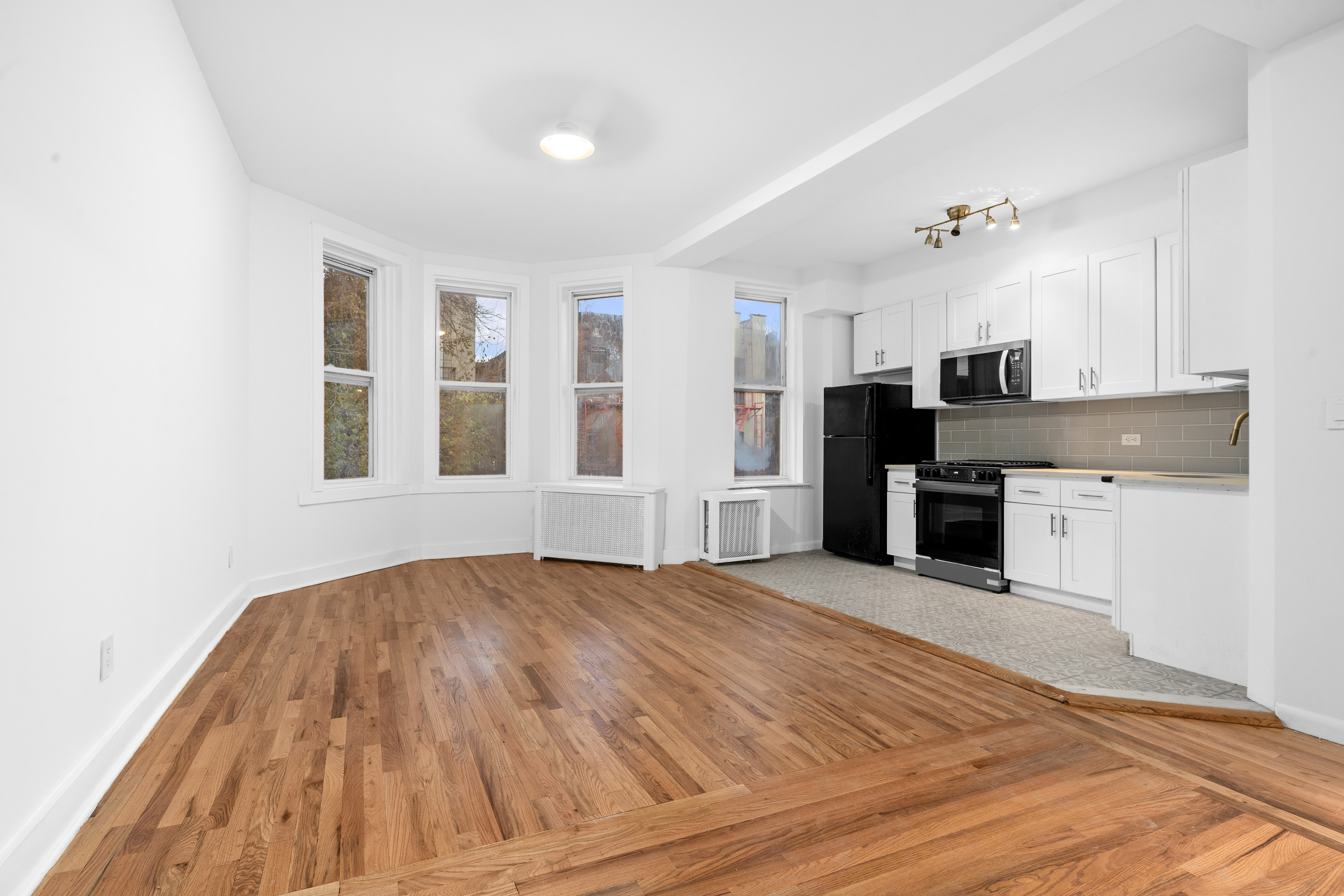 339 East 29th Street Brooklyn, NY 11226 - Photo 11 of 21 a view of a kitchen with microwave and cabinets