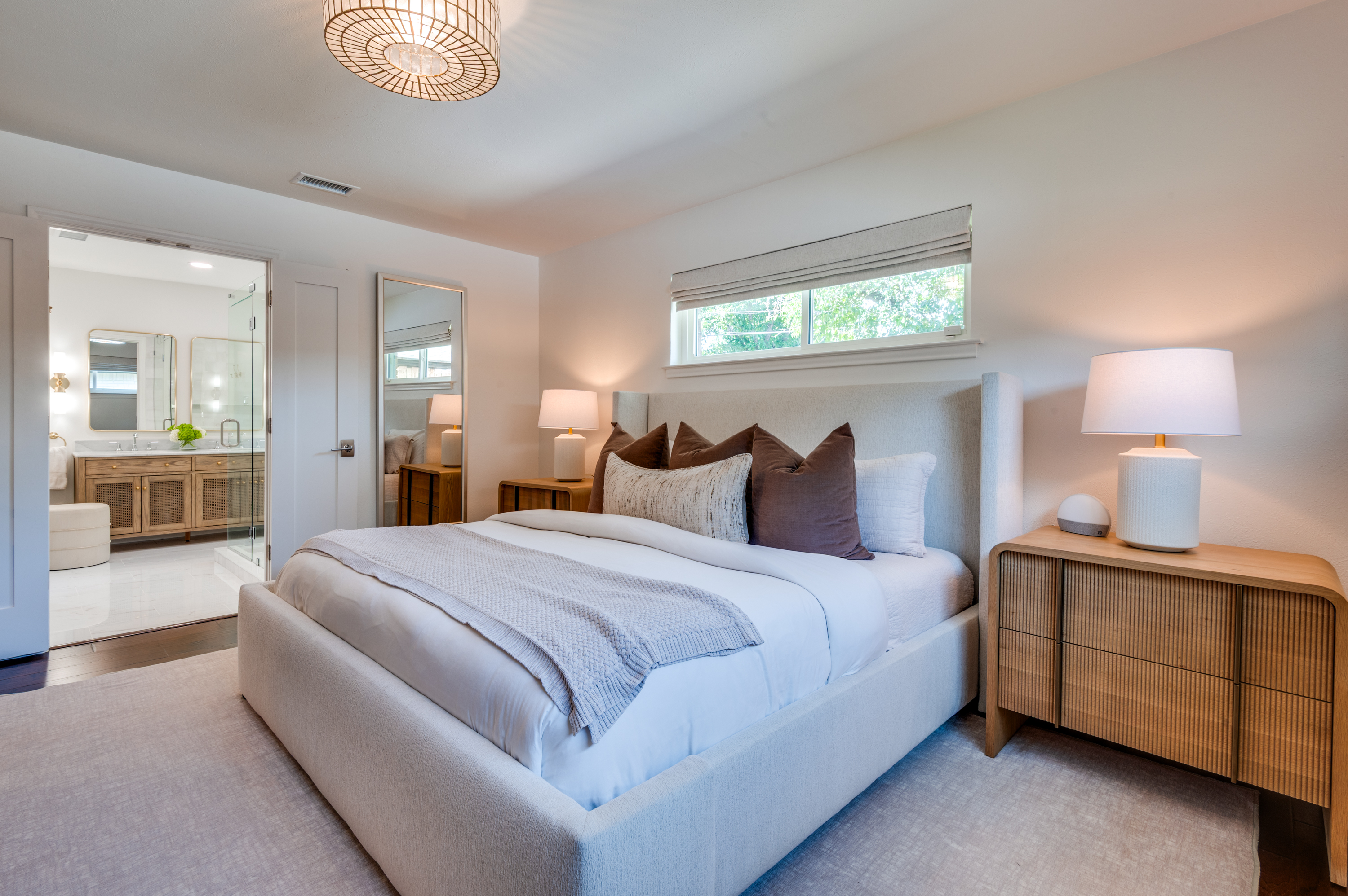 3363 Merrell Road Dallas, TX 75229 - Photo 16 of 29 a spacious bedroom with a bed and a lamp