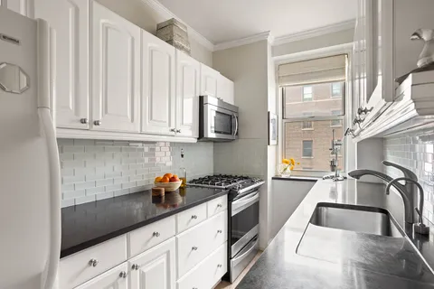 a kitchen with stainless steel appliances granite countertop a sink stove and cabinets