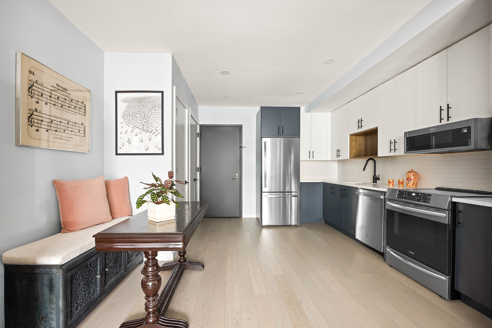 511 Evergreen Avenue, Unit 3D Brooklyn, NY 11221 - Photo 3 of 8 a kitchen with stainless steel appliances wooden floor and a refrigerator