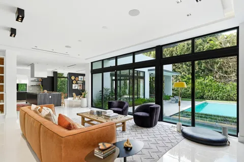 a living room with furniture and large windows