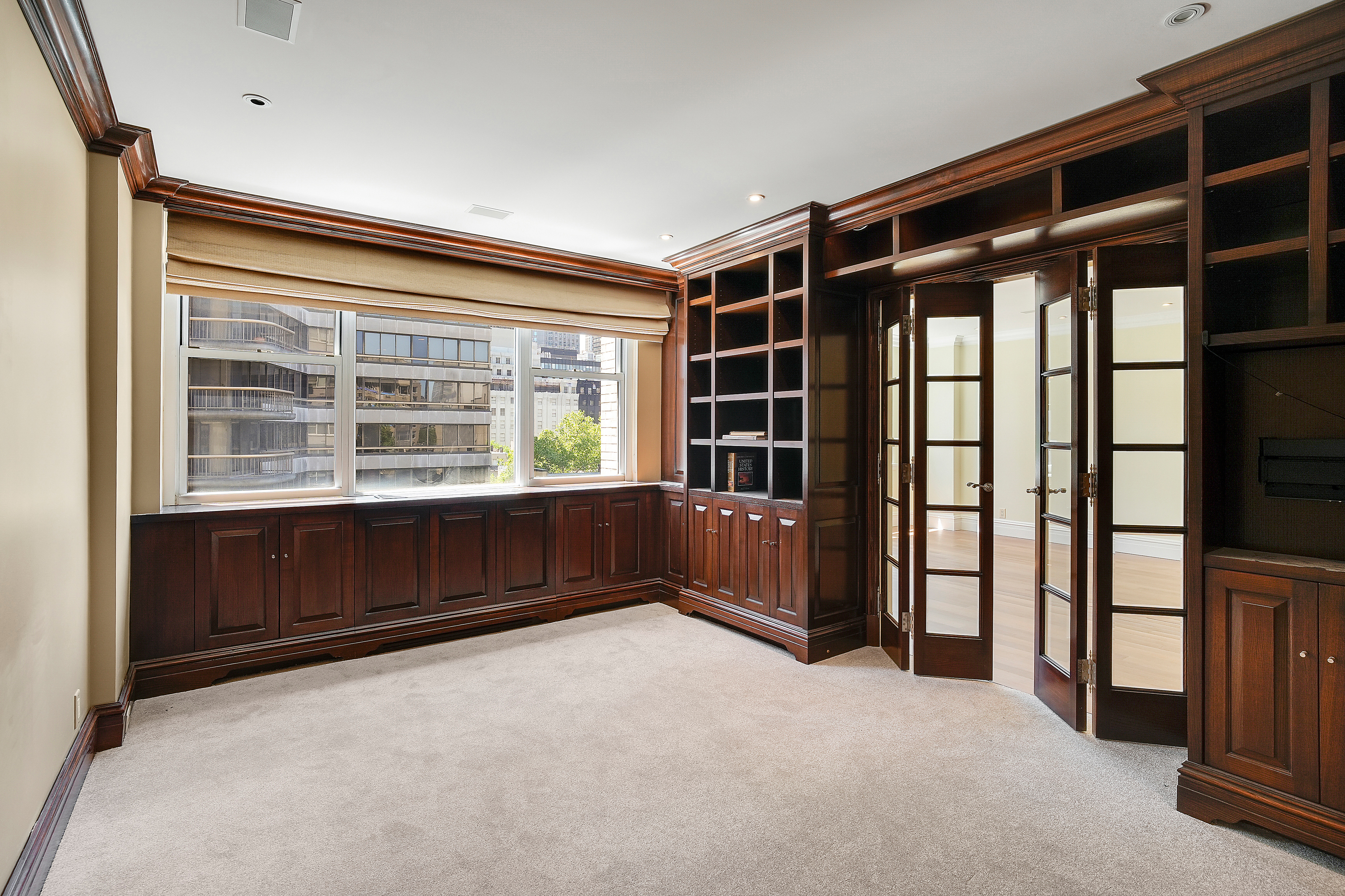 175 East 62nd Street, Unit 8D Manhattan, NY 10065 - Photo 13 of 24 a view of an empty room with a window