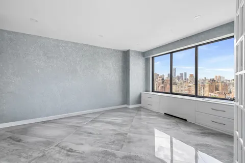 an empty room with large windows