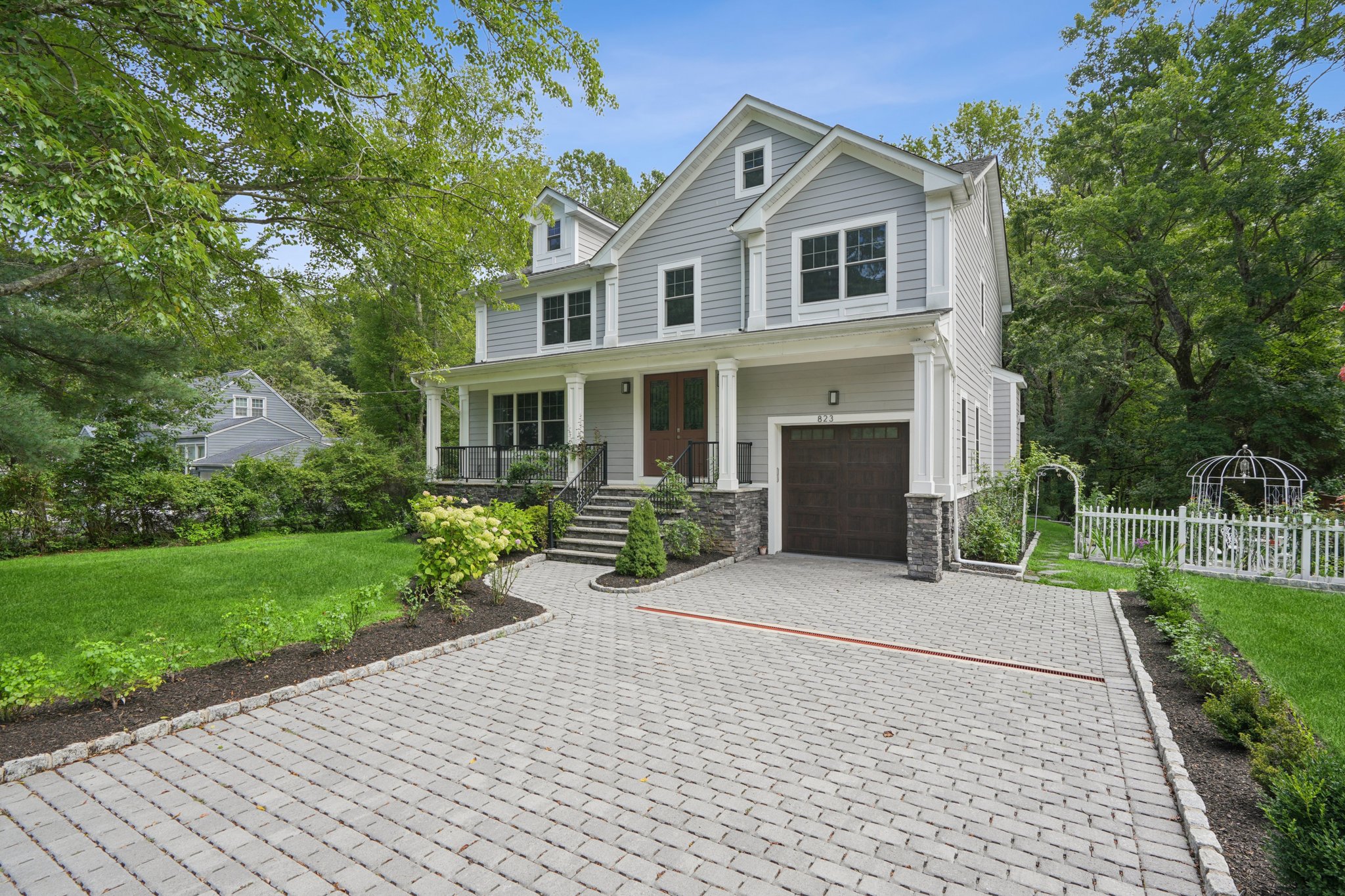 823 River Road Chatham, NJ 07928 - Photo 2 of 60 a front view of a house with a yard and potted plants