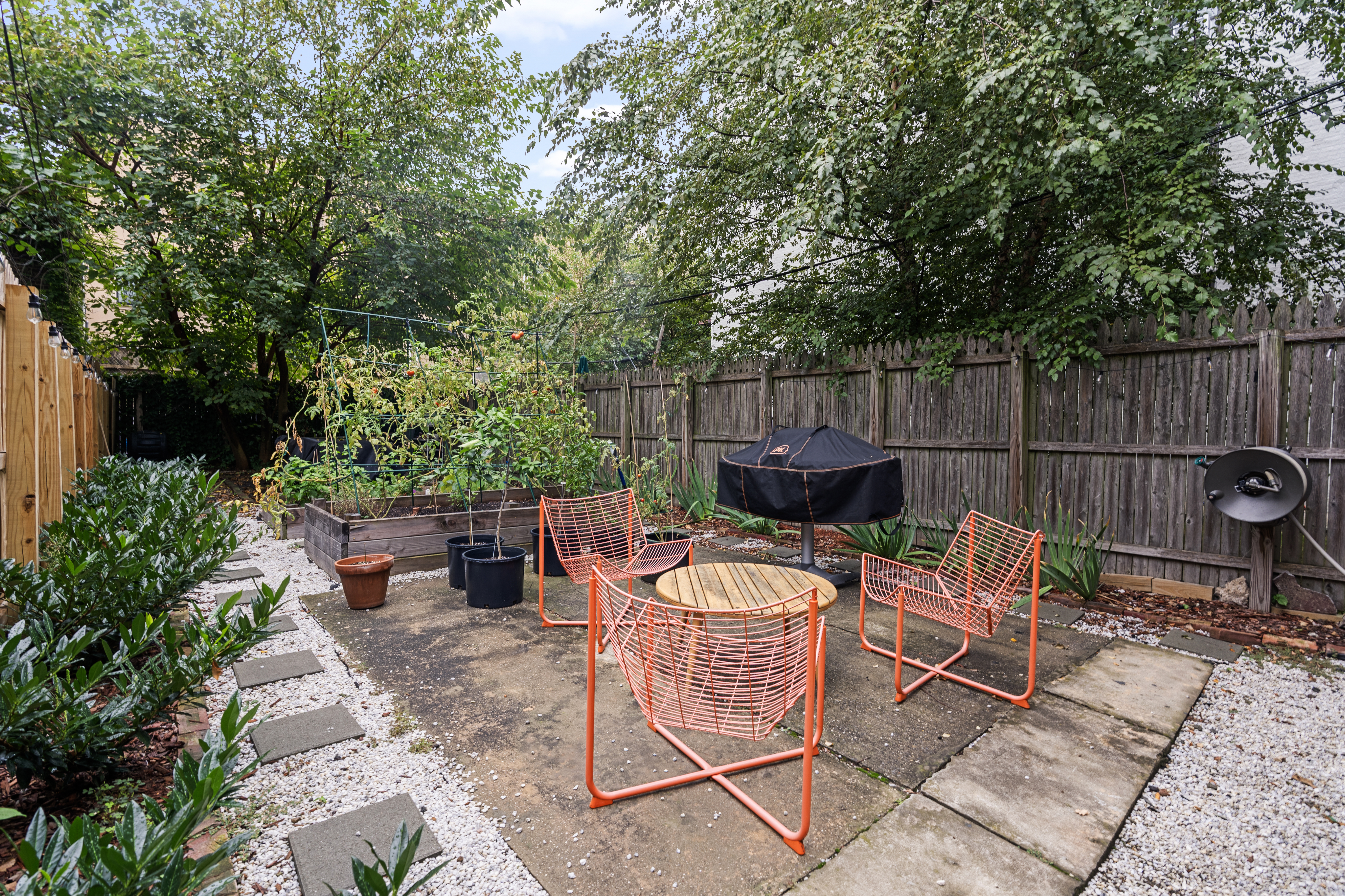 660 Saint Marks Avenue Brooklyn, NY 11216 - Photo 19 of 21 a backyard of a house with fountain table and chairs