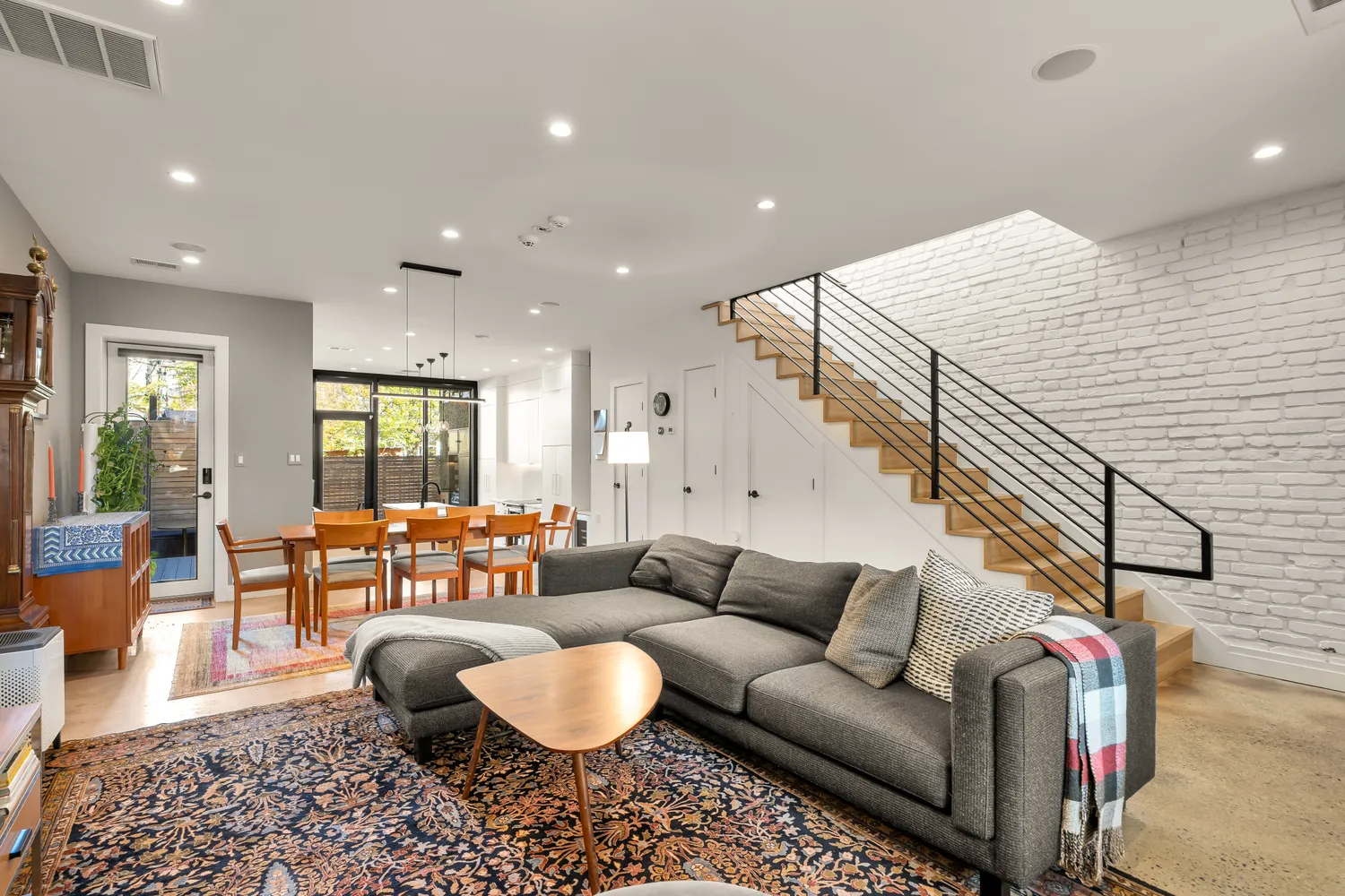 a living room with furniture and wooden floor