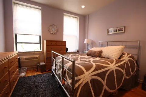 a bedroom with two beds and a window