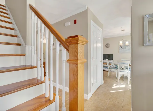 a view of a hallway with wooden floor and staircase