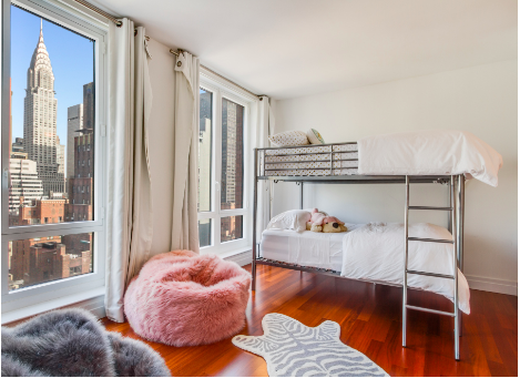 45 Park Avenue, Unit 2101 Manhattan, NY 10016 - Photo 7 of 10 a bedroom with furniture and a window