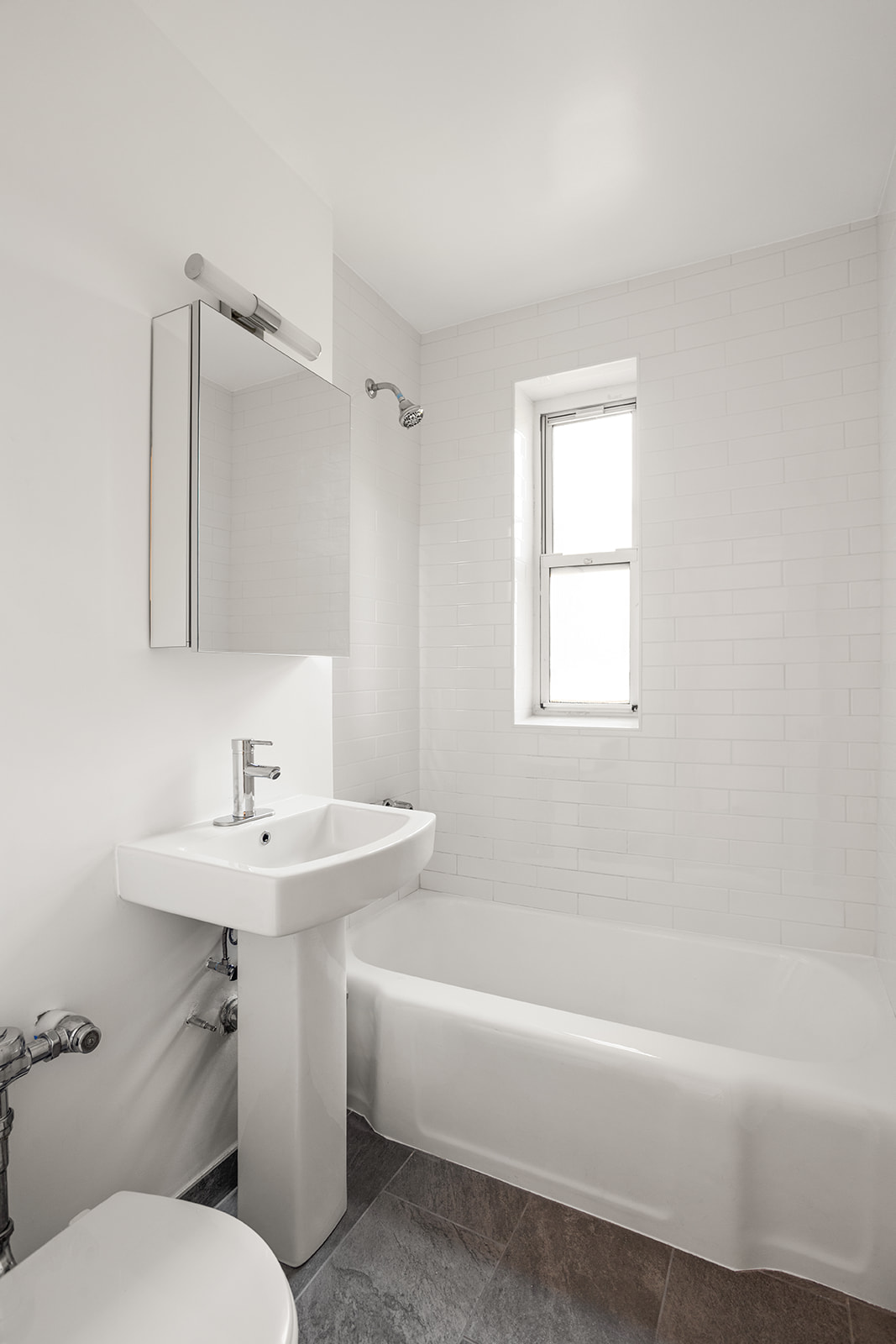 33-35 81st Street, Unit 5A Queens, NY 11372 - Photo 6 of 12 a bathroom with a sink a toilet and shower