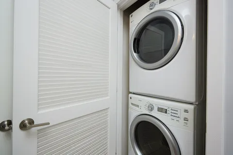 a close view of a utility room with dryer and washer