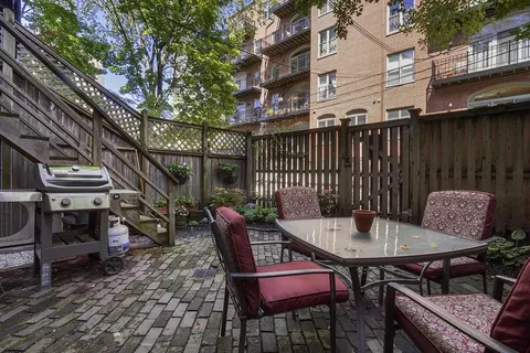 a car parked in front of a brick house