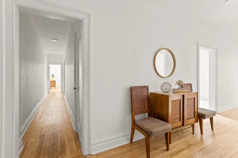 a view of a hallway with wooden floor and workspace