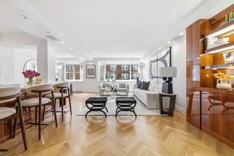 a living room with furniture dining table and a window