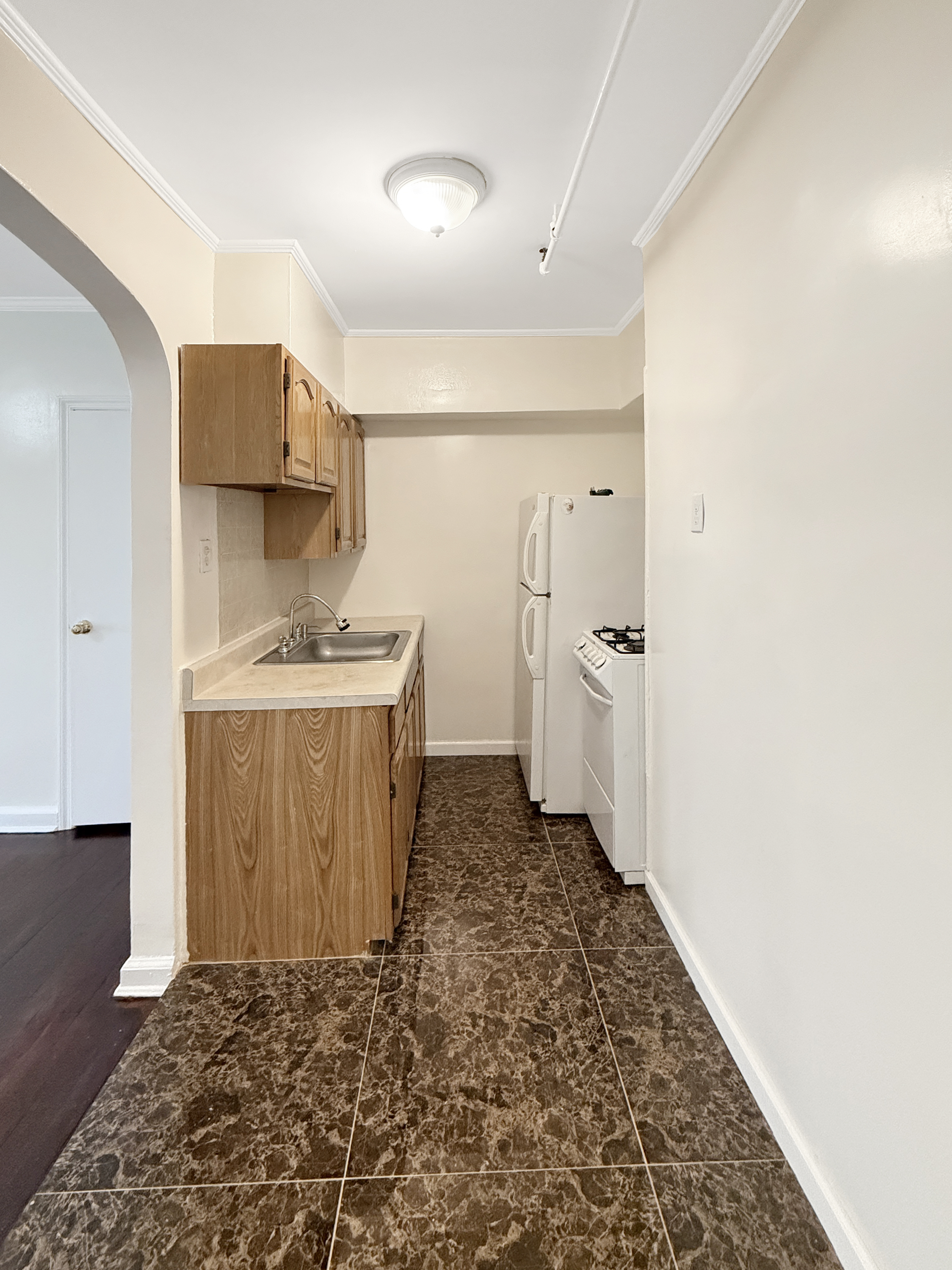 4215 Atlantic Avenue Brooklyn, NY 11224 - Photo 9 of 21 a bathroom with a sink a toilet and a shower