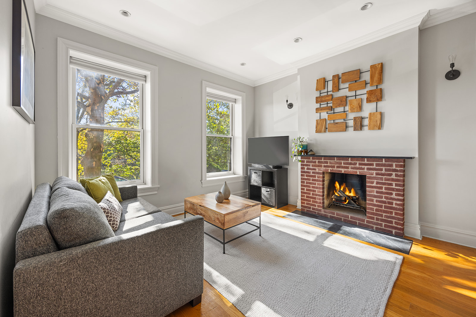 493 18th Street, Unit 2 Brooklyn, NY 11215 - Photo 2 of 13 a living room with furniture and a fireplace